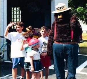 Smokey The Bear with some local kids